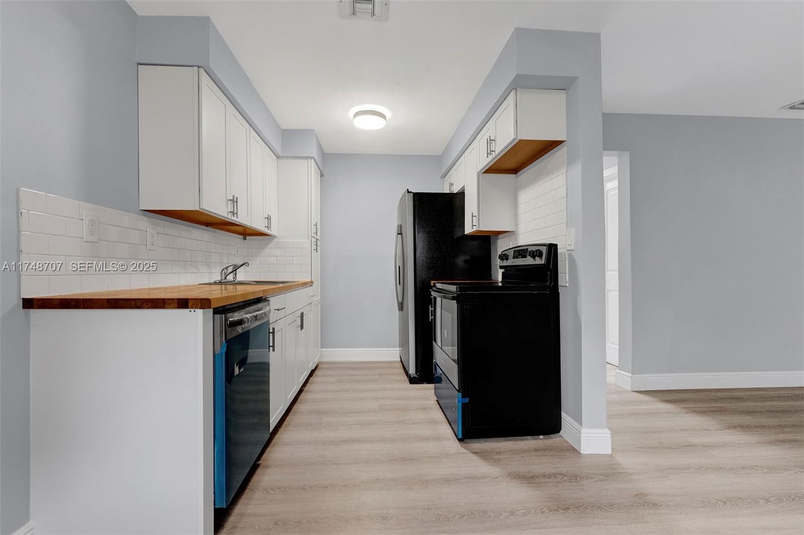 1120 Southwest 30th Street, Unit A Fort Lauderdale, FL 33315 - Photo 17 of 29 a kitchen with a refrigerator and a stove