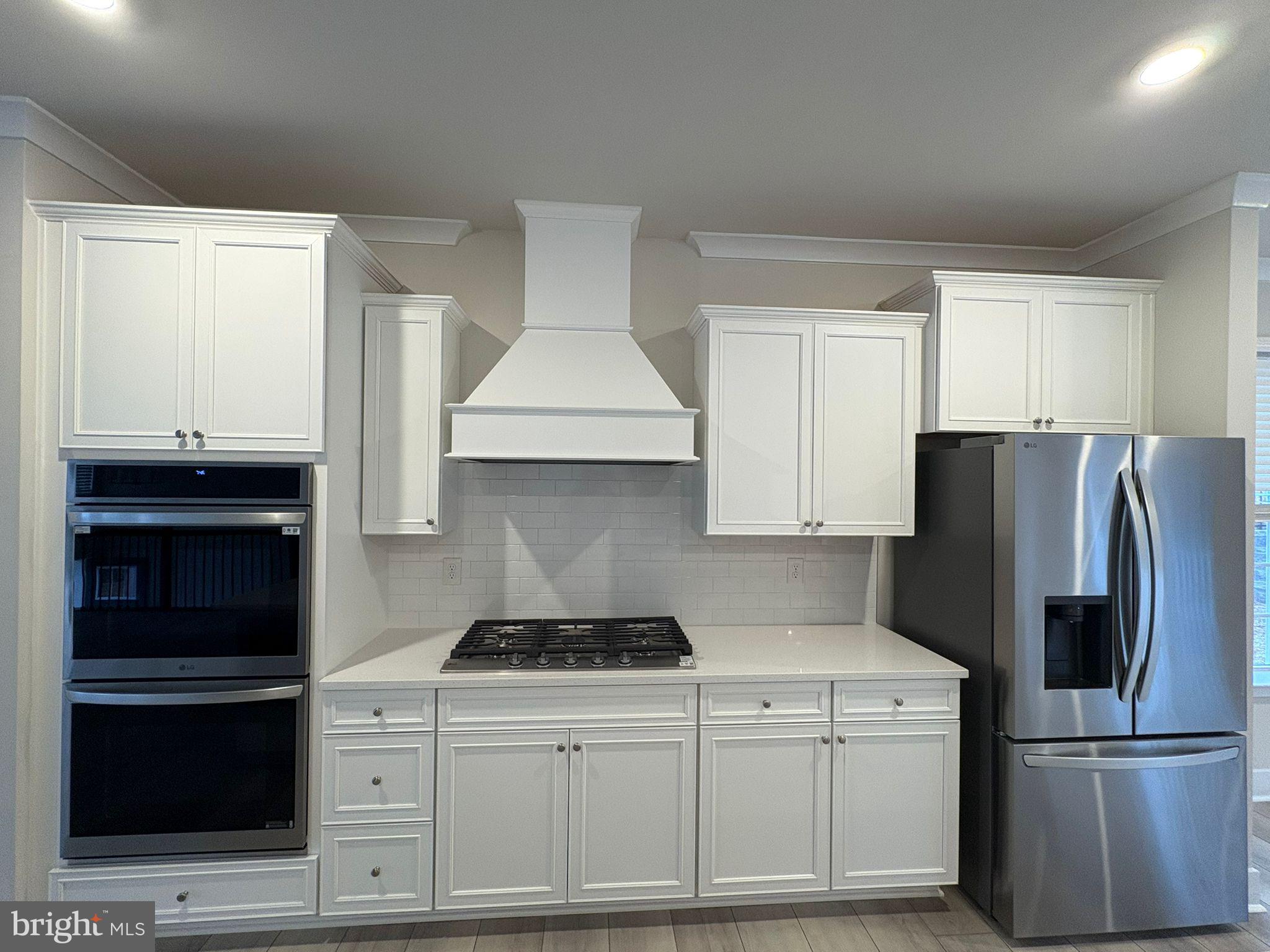 1759 Water Xing Road Baltimore, MD 21208 - Photo 2 of 15 a kitchen with a refrigerator and a stove top oven