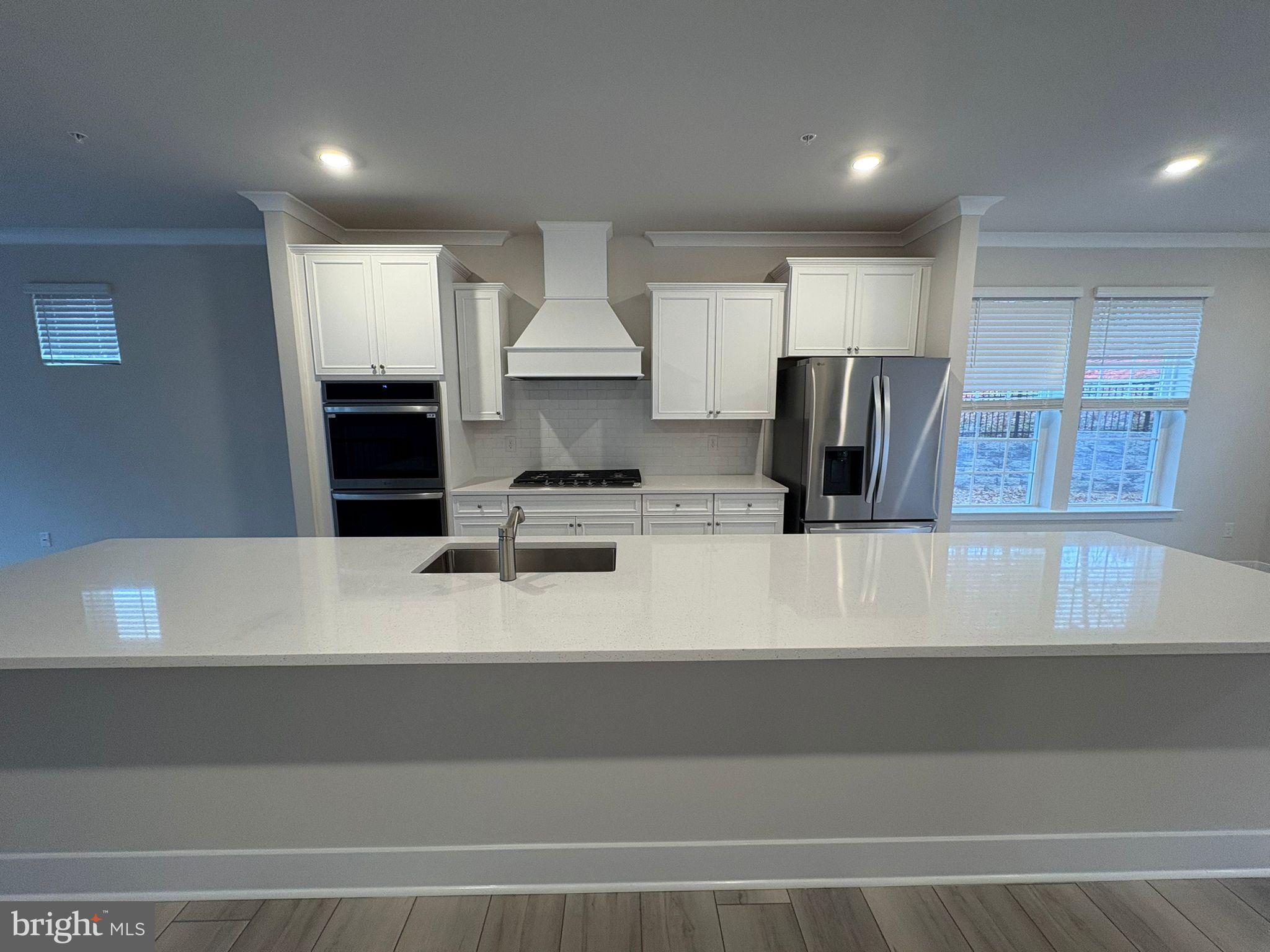 1759 Water Xing Road Baltimore, MD 21208 - Photo 3 of 15 a kitchen with kitchen island a counter top a stove and a refrigerator