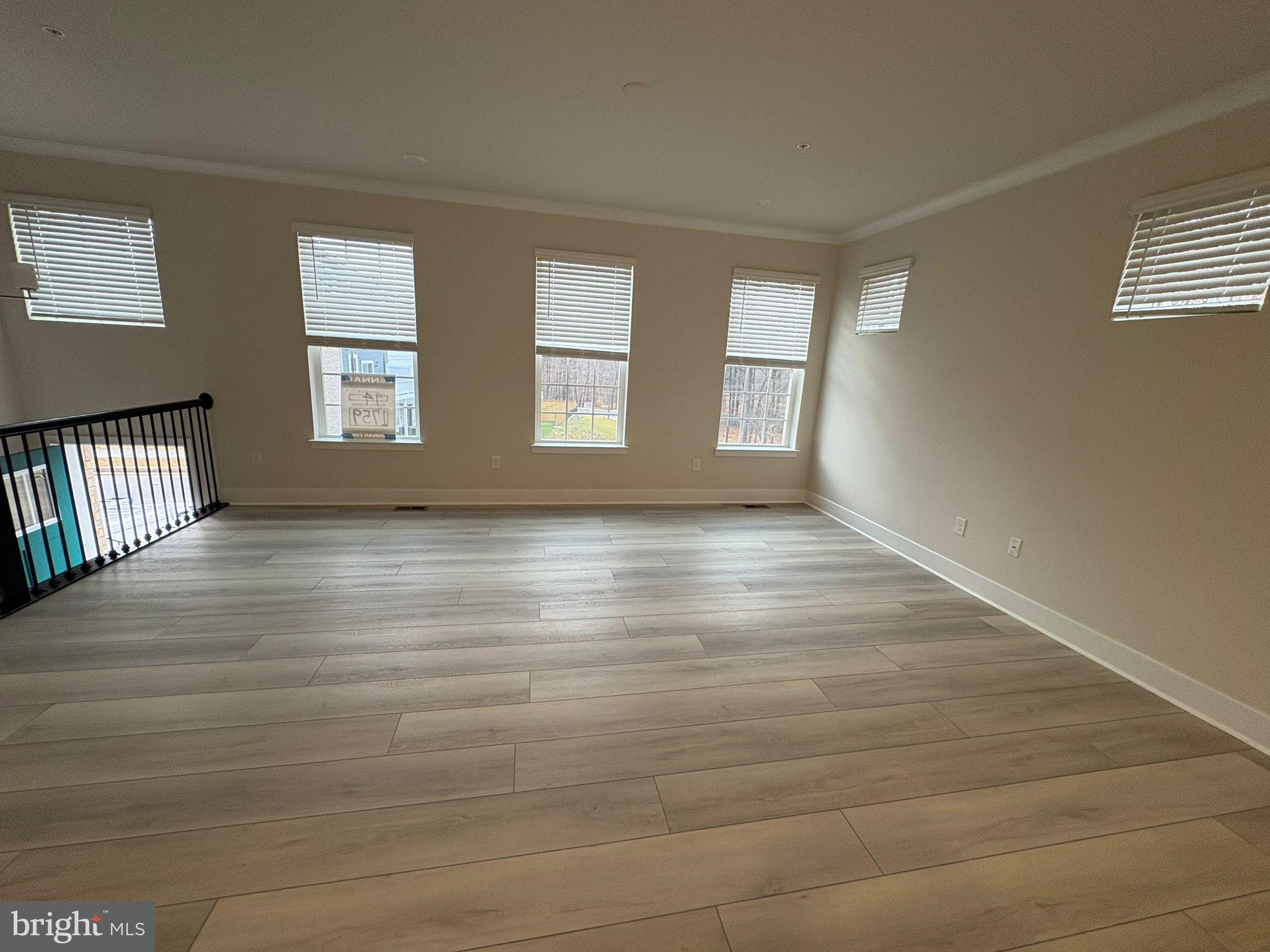 1759 Water Xing Road Baltimore, MD 21208 - Photo 6 of 15 a view of an empty room with wooden floor and a window