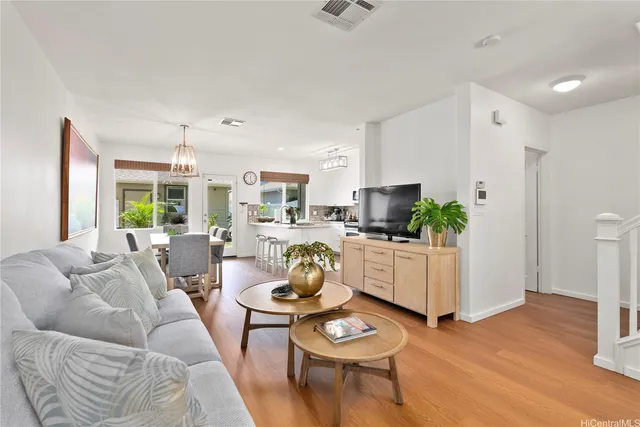a living room with furniture potted plant and a large mirror