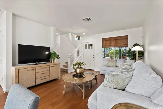 a kitchen with a refrigerator a stove a sink and chairs