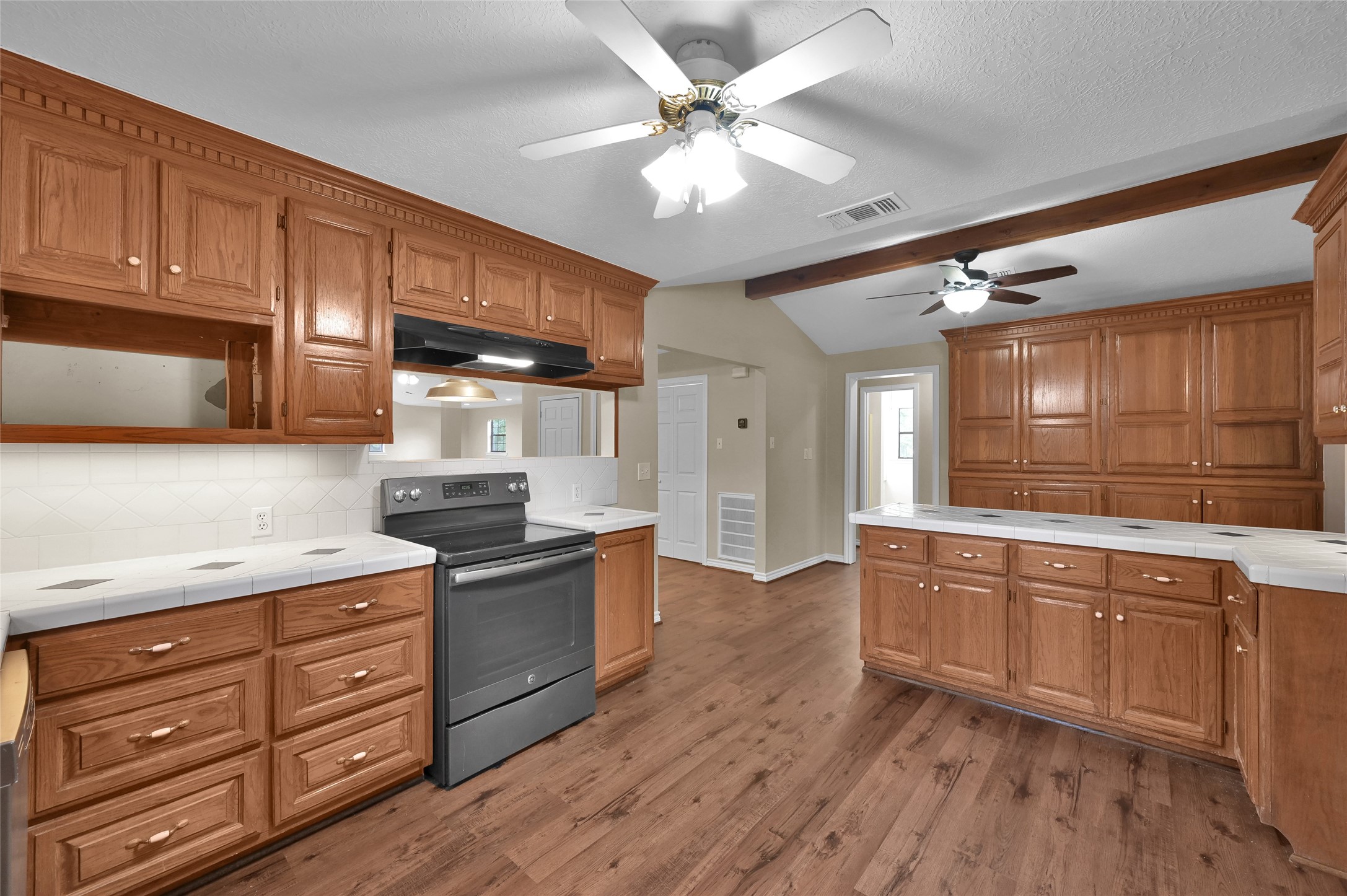 511 East Front Street New Waverly, TX 77358 - Photo 12 of 38 a kitchen with stainless steel appliances granite countertop a stove and cabinets