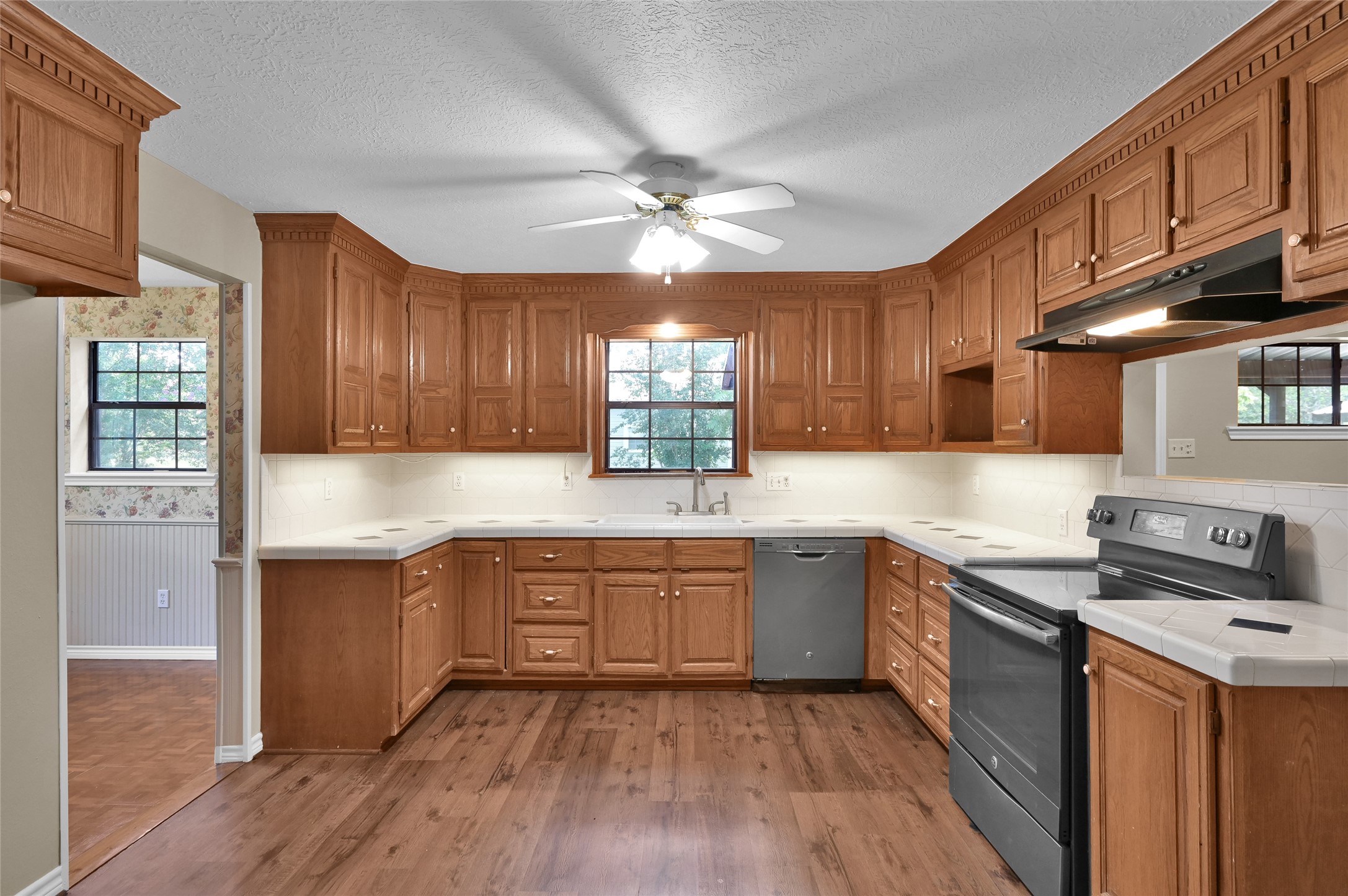 511 East Front Street New Waverly, TX 77358 - Photo 16 of 38 a kitchen with stainless steel appliances granite countertop wooden cabinets and a stove top oven