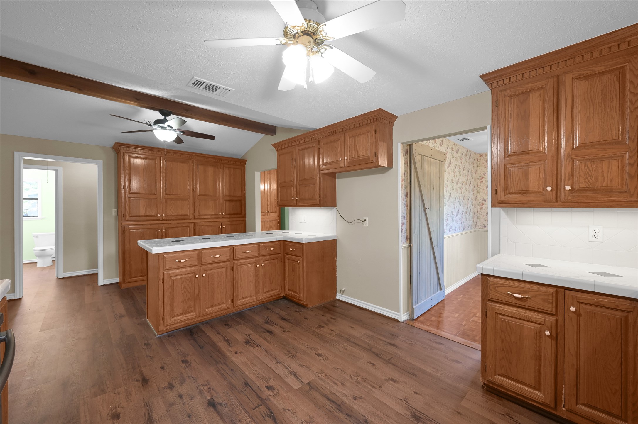 511 East Front Street New Waverly, TX 77358 - Photo 21 of 38 a kitchen with stainless steel appliances granite countertop a refrigerator a sink dishwasher a stove and white countertops with wooden floor