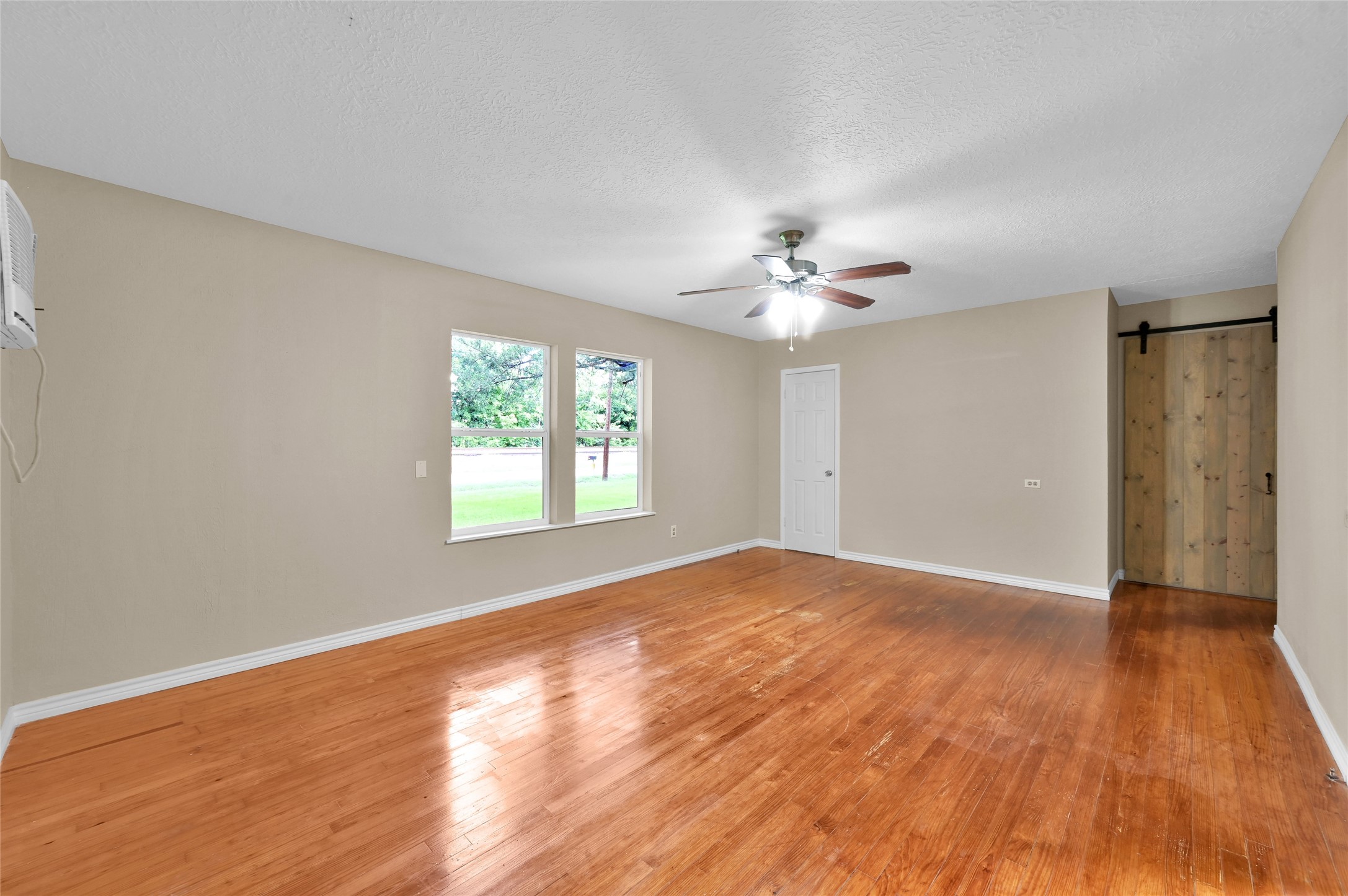 511 East Front Street New Waverly, TX 77358 - Photo 28 of 38 a view of an empty room with wooden floor and a window
