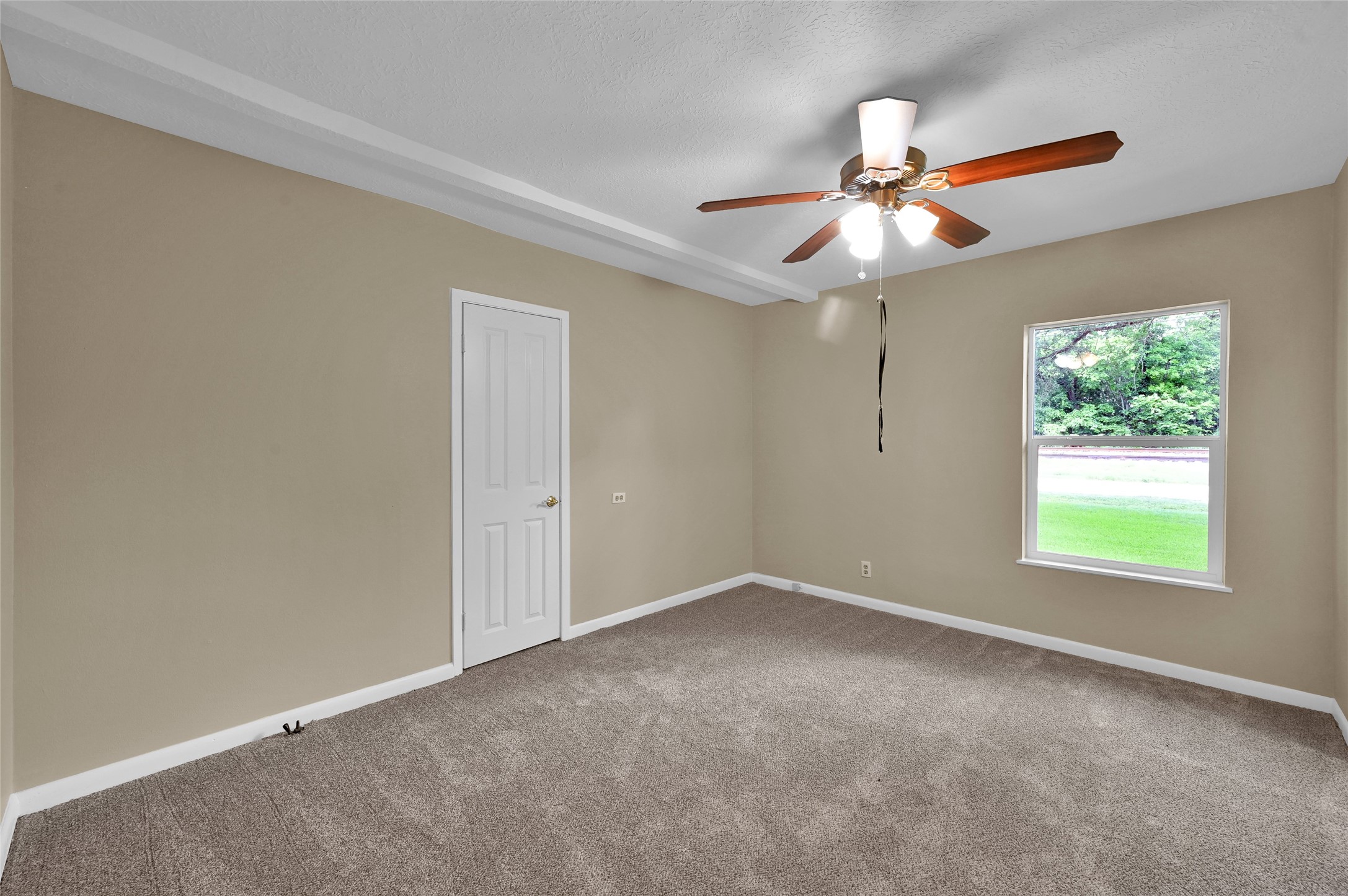 511 East Front Street New Waverly, TX 77358 - Photo 29 of 38 an empty room with windows and fan