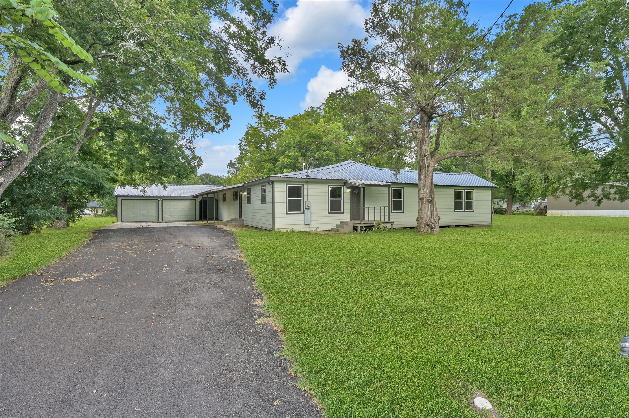 511 East Front Street New Waverly, TX 77358 - Photo 5 of 38 a front view of a house with a yard and trees