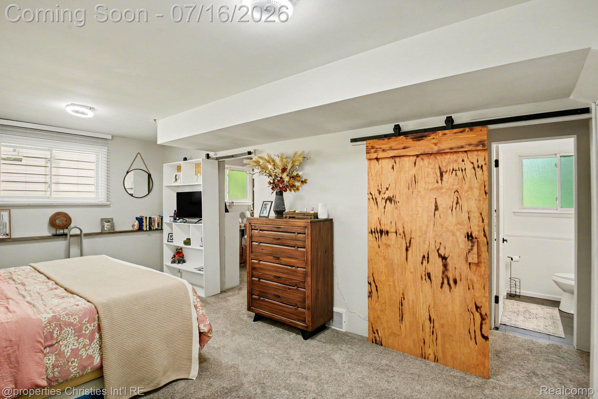 3304 Riverside Drive Port Huron, MI 48060 - Photo 11 of 26 Carpeted interior space featuring a wood-finish barn door, white trim, and recessed lighting