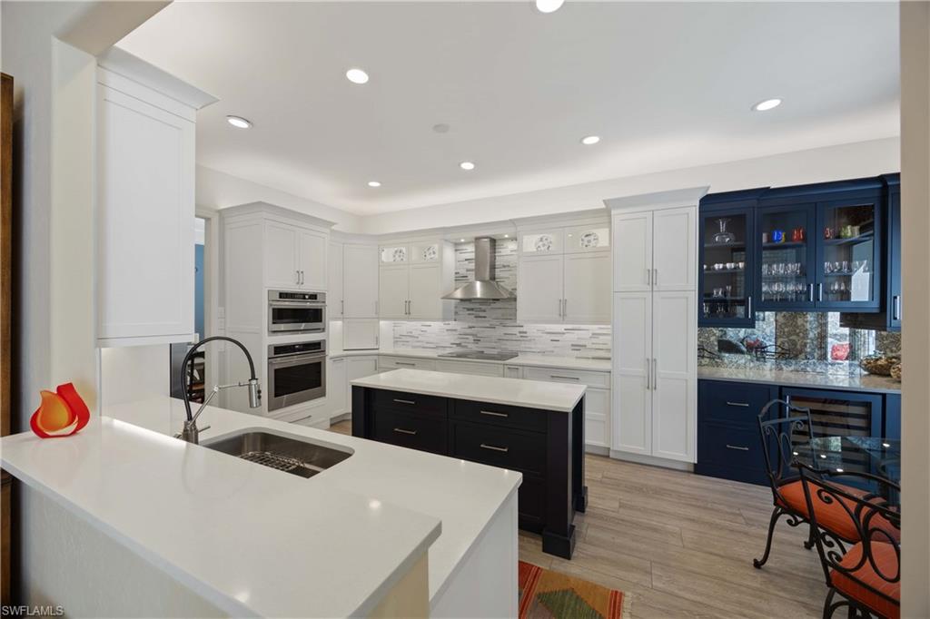 1936 Timarron Way Naples, FL 34109 - Photo 13 of 49 a kitchen with stainless steel appliances granite countertop a sink stove and cabinets
