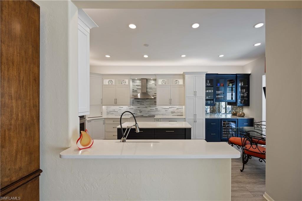 1936 Timarron Way Naples, FL 34109 - Photo 14 of 49 a large white kitchen with a large window