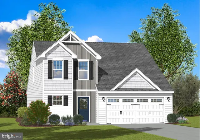 a view of a white house next to a yard with large trees