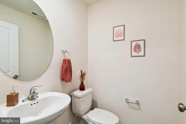 a bathroom with a double vanity sink toilet and shower