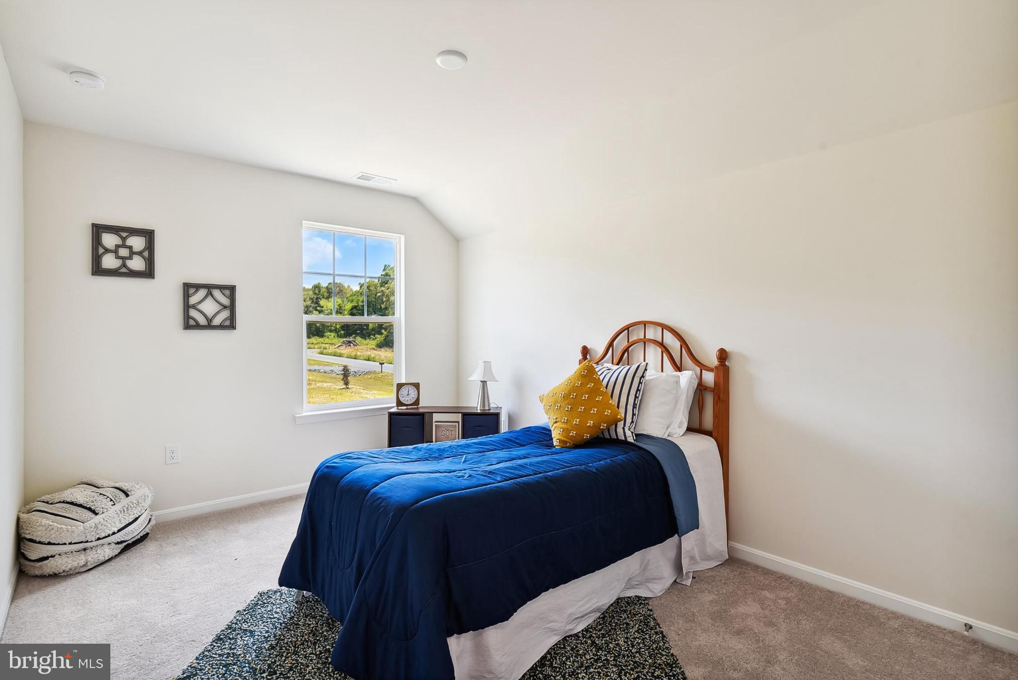 26571 Line Road Seaford, DE 19973 - Photo 24 of 26 a bed sitting in a bedroom next to a window and a lamp