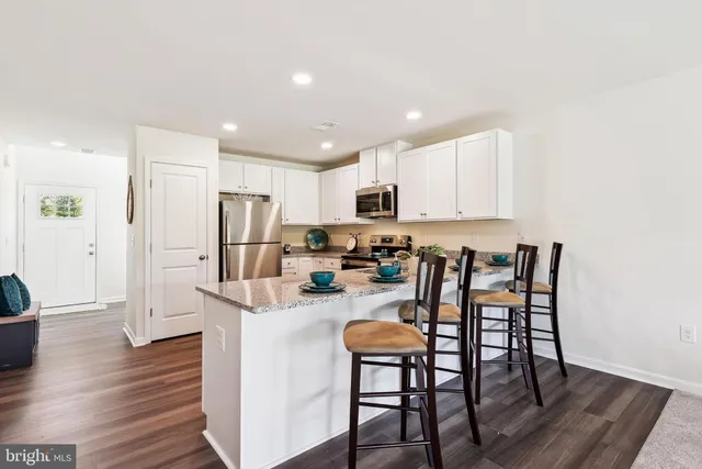 a living room with furniture a window and a flat screen tv
