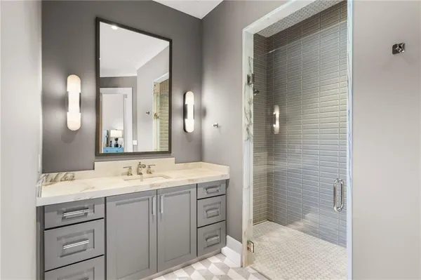 a bathroom with a granite countertop sink a toilet and shower