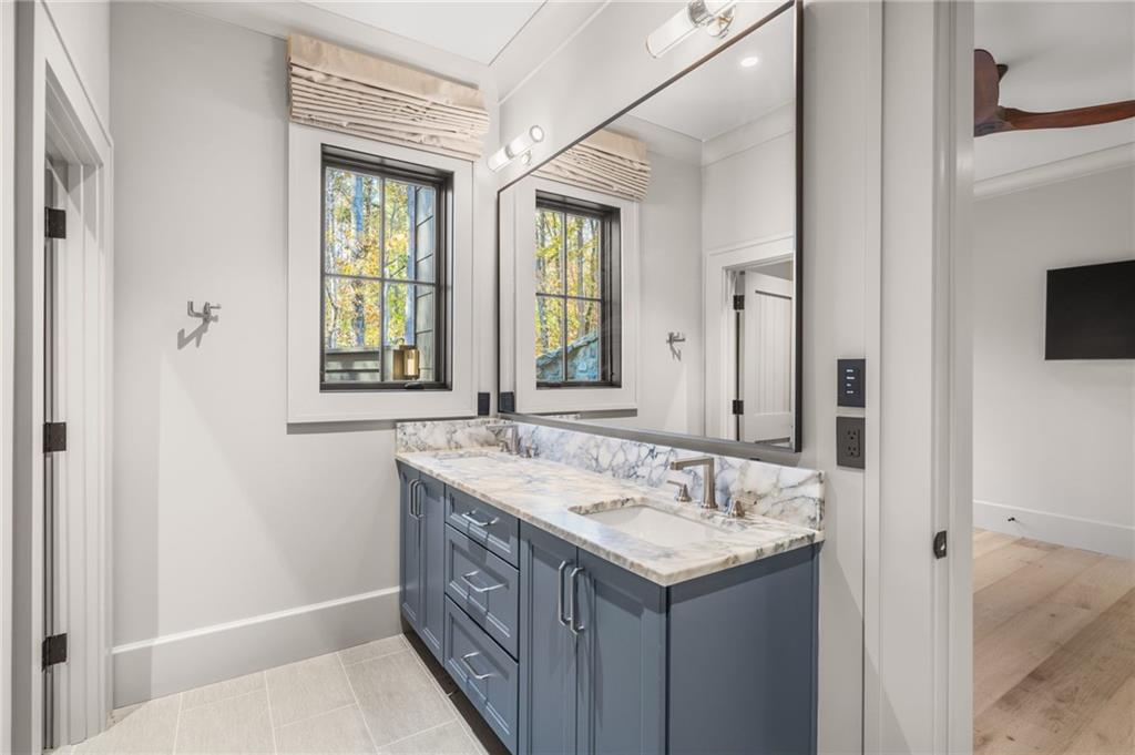 6091 GC Crow Road Flowery Branch, GA 30542 - Photo 79 of 100 a bathroom with a sink and a mirror