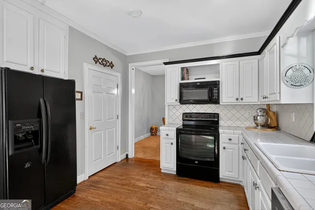 a kitchen with a refrigerator stove and microwave