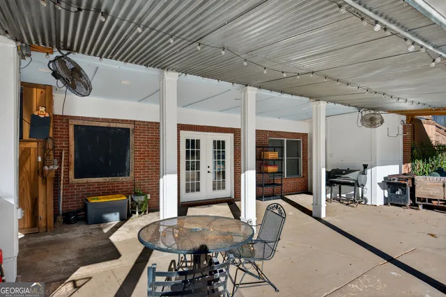 a view of a porch with furniture and a yard