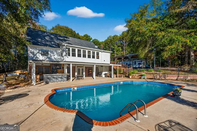 a view of a swimming pool with lounge chairs