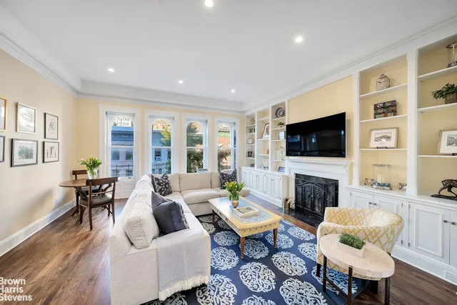a living room with fireplace furniture and a flat screen tv