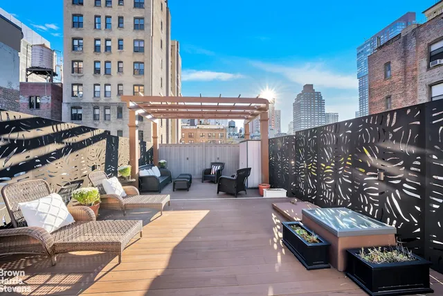 a view of a patio with a table and chairs and potted plants