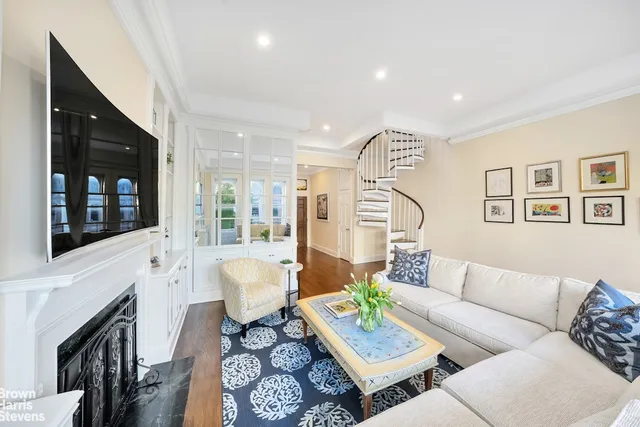 a living room with fireplace furniture and a flat screen tv