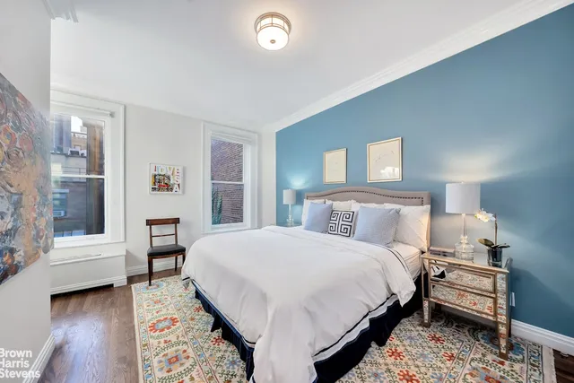 a bedroom with a bed and a chair