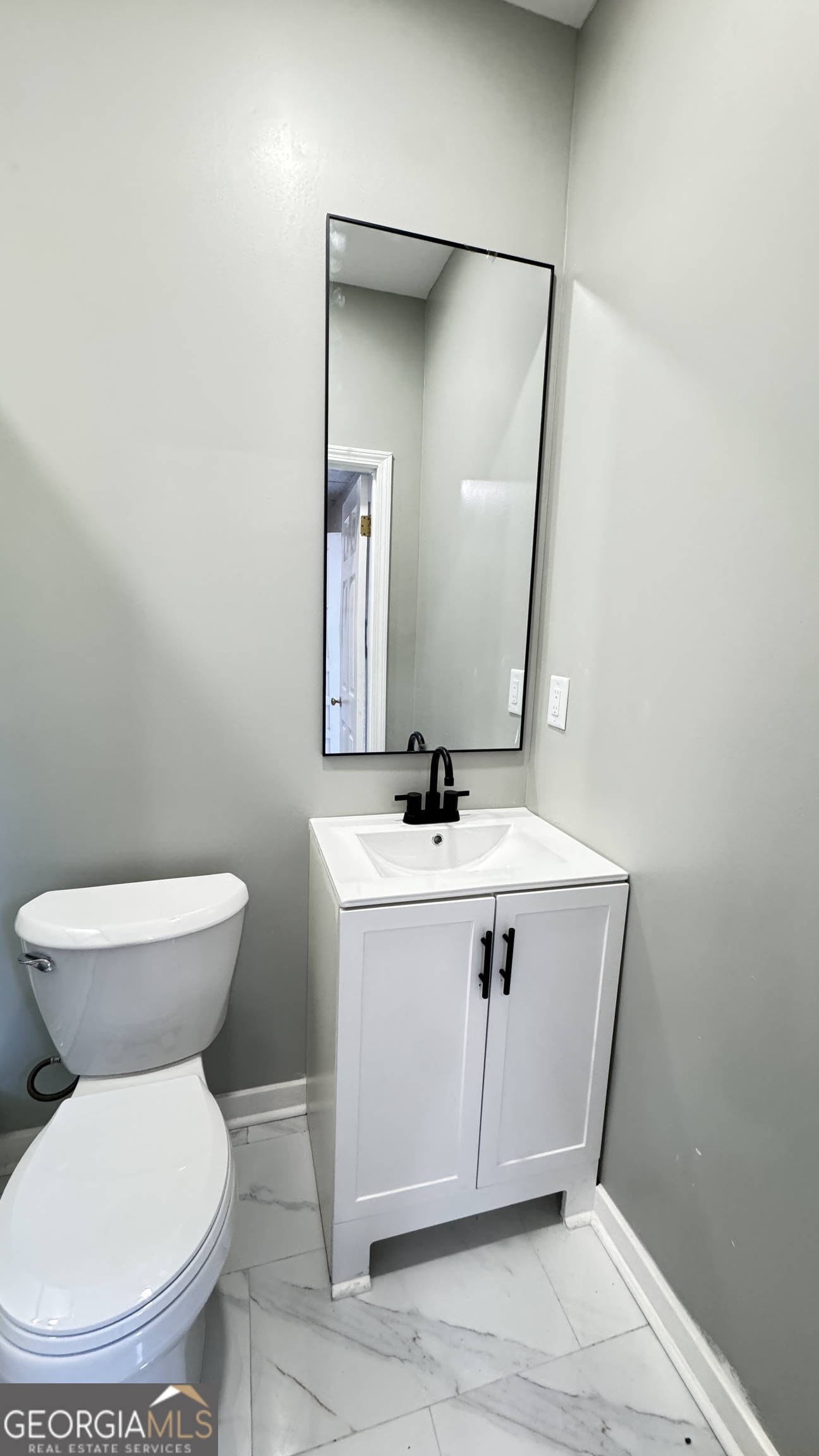 723 Sheffield Road Norcross, GA 30071 - Photo 4 of 8 a bathroom with a toilet sink and mirror