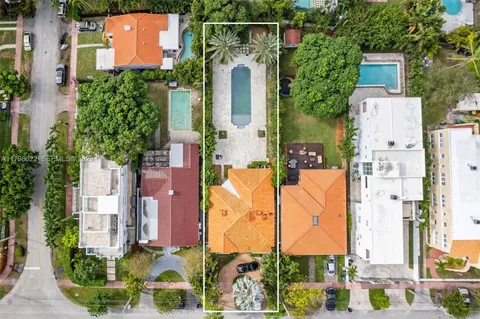 an aerial view of residential houses with outdoor space and parking