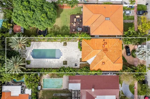 an aerial view of houses with a yard