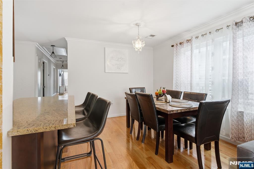 944 Flora Street Elizabeth, NJ 07201 - Photo 13 of 37 a view of a dining room with furniture and wooden floor