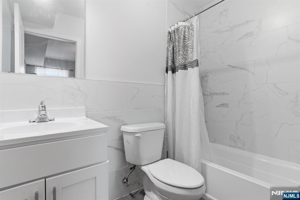 944 Flora Street Elizabeth, NJ 07201 - Photo 29 of 37 a white toilet sitting next to a bathroom sink