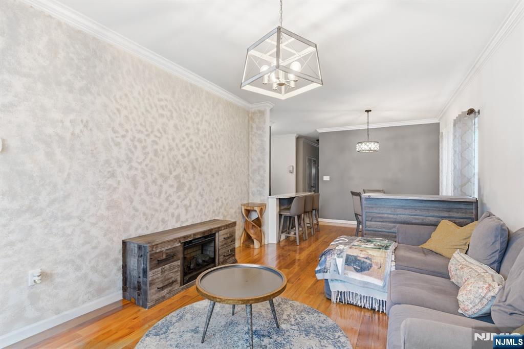 944 Flora Street Elizabeth, NJ 07201 - Photo 3 of 37 a living room with furniture and a chandelier