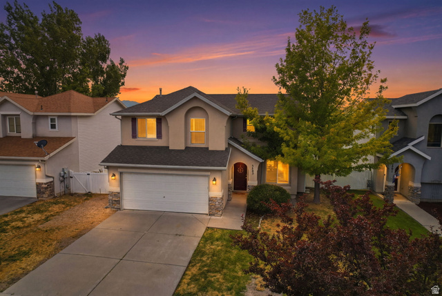 5485 Heather Way Tooele, UT 84074 - Photo 1 of 41 Two-story residence featuring a two-car garage with stone veneer accents and exterior wall sconces