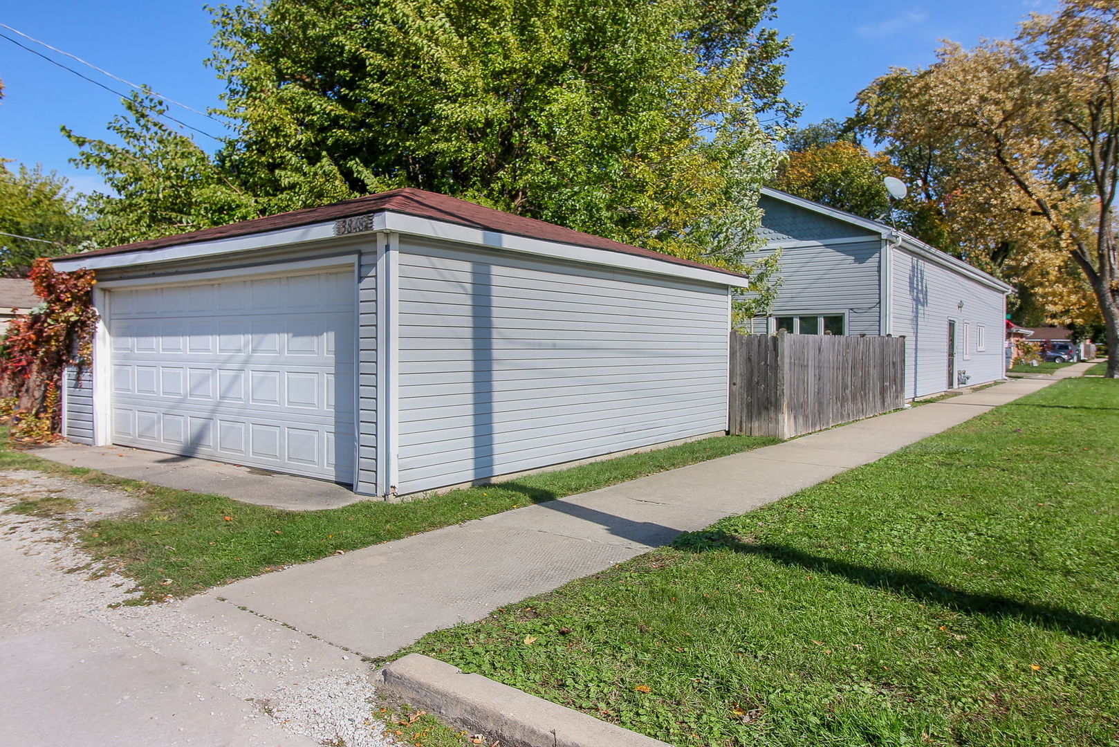 3848 Harrison Avenue Brookfield, IL 60513 - Photo 12 of 12 a backyard of a house with plants and large tree