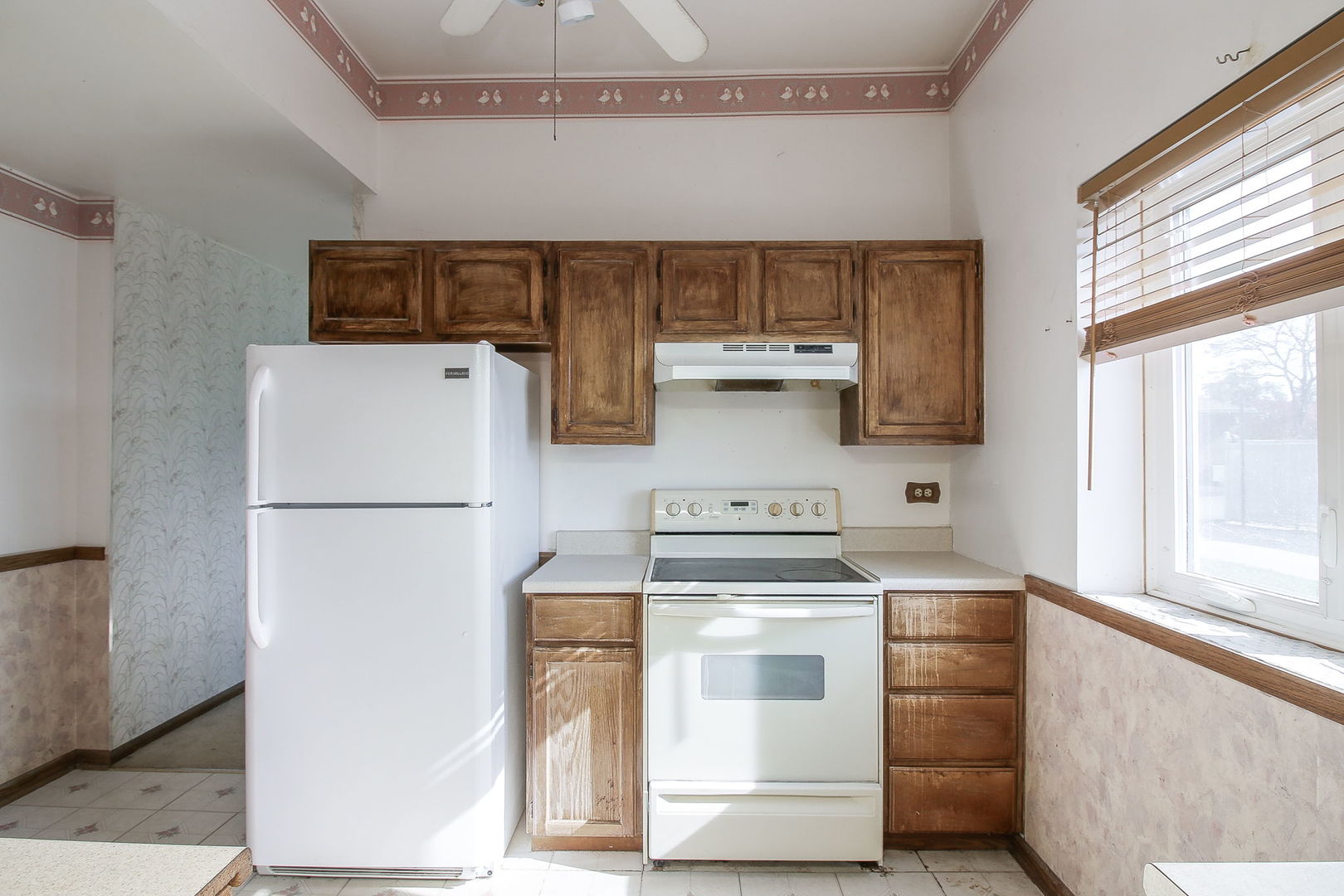 3848 Harrison Avenue Brookfield, IL 60513 - Photo 5 of 12 a kitchen with appliances a refrigerator and a window