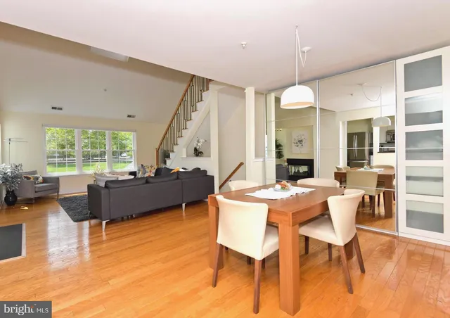 a living room with fireplace furniture and a large window