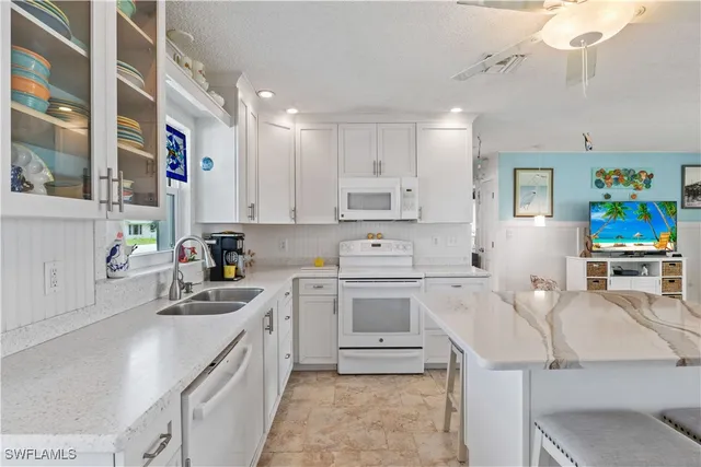 a kitchen that has a lot of cabinets in it and appliances
