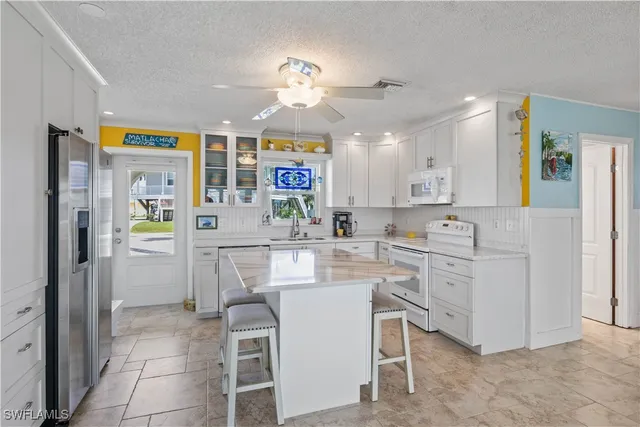 a kitchen with a refrigerator and a sink