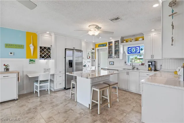 a kitchen with table chairs cabinets and stainless steel appliances