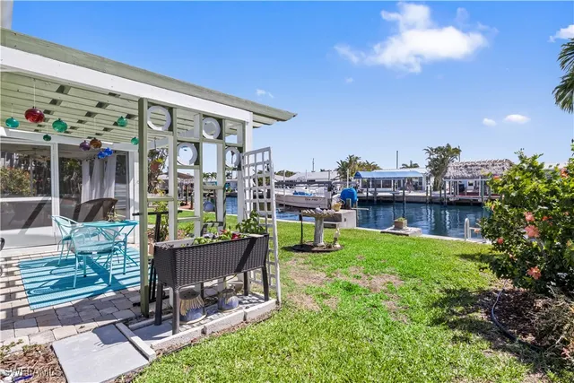 a view of a chairs and table in backyard of the house