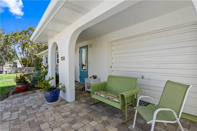 a view of backyard with outdoor seating and plants