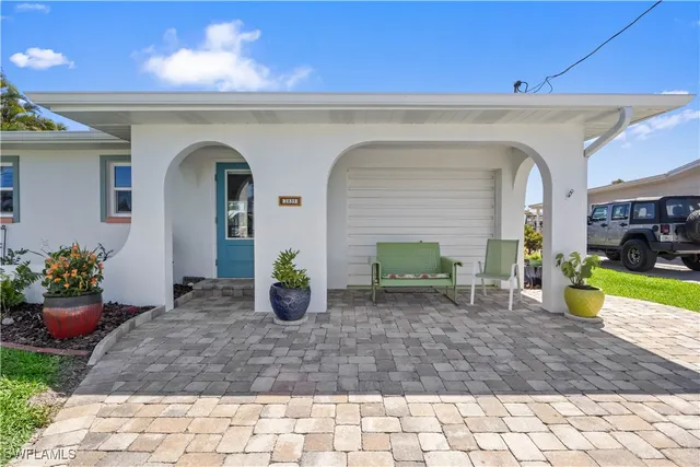 a view of a house with potted plants