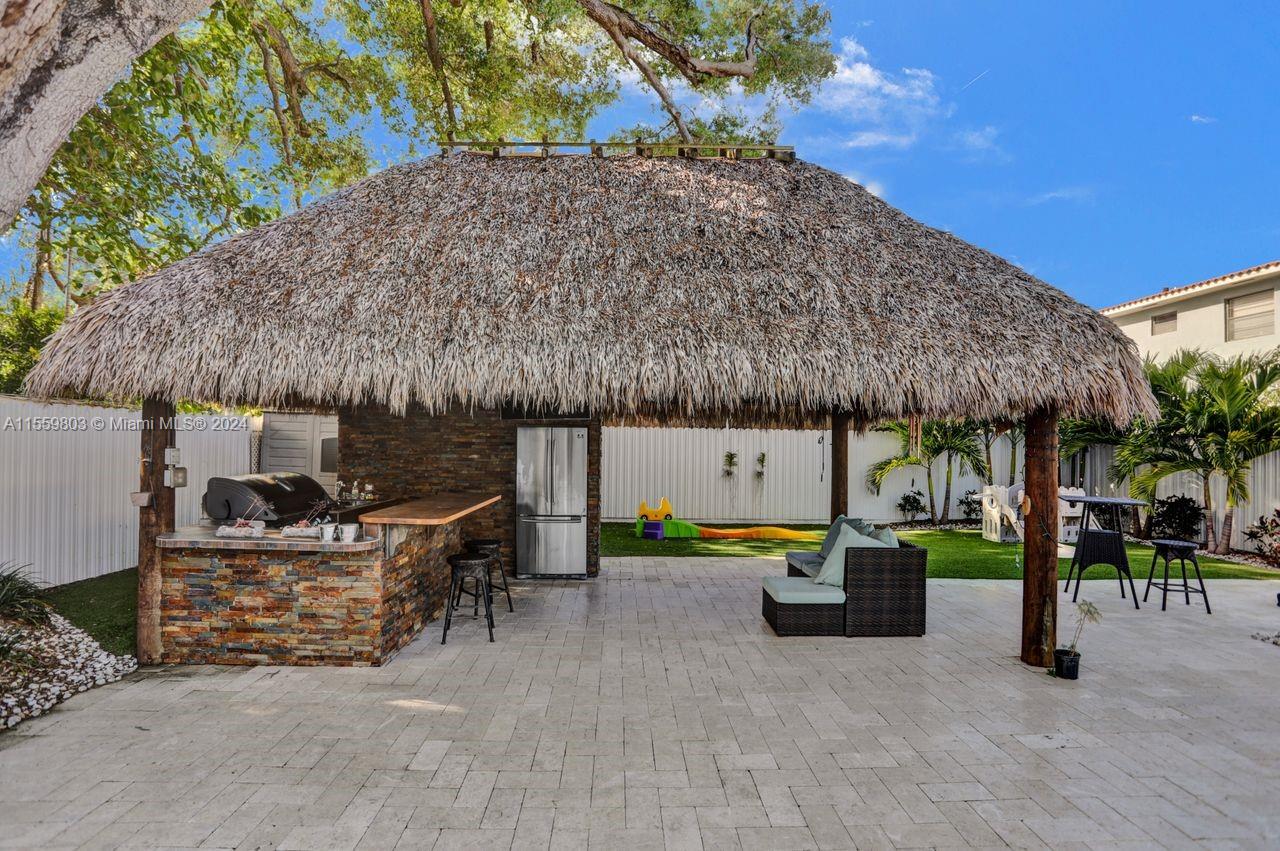 2800 Southwest 26th Street Miami, FL 33133 - Photo 15 of 72 a view of a patio with table and chairs under an umbrella