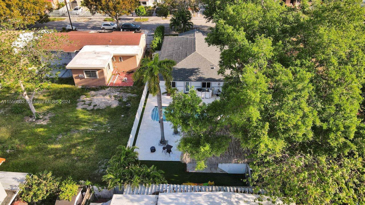 2800 Southwest 26th Street Miami, FL 33133 - Photo 25 of 72 an aerial view of a house with a yard and large trees