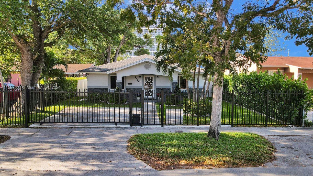 2800 Southwest 26th Street Miami, FL 33133 - Photo 38 of 72 a view of a house with a backyard and a tree