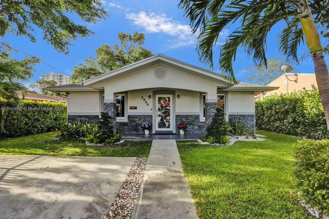 2800 Southwest 26th Street Miami, FL 33133 - Photo 42 of 72 a view of a white house with a yard plants and palm trees