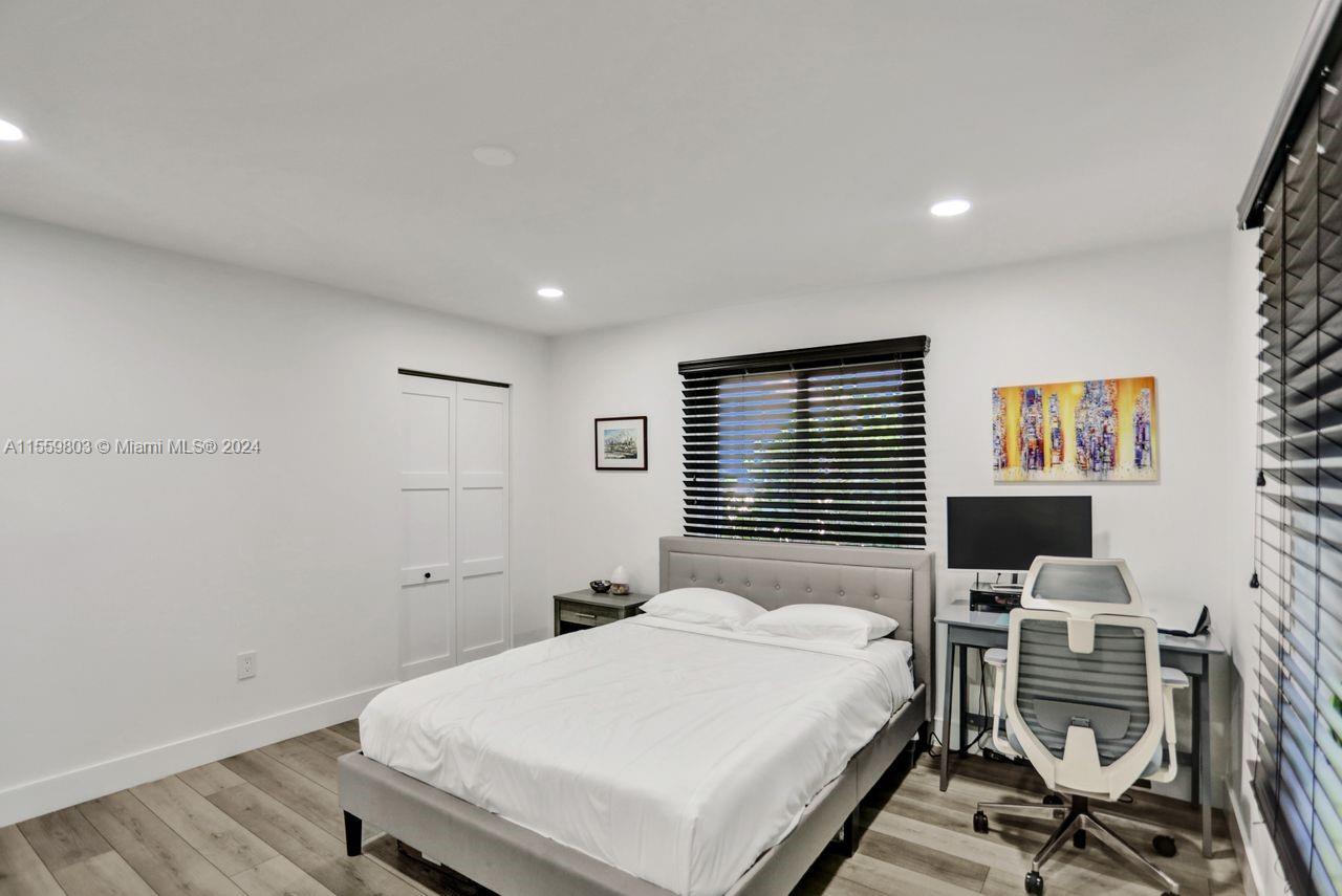 2800 Southwest 26th Street Miami, FL 33133 - Photo 47 of 72 a bedroom with a bed and wooden floor