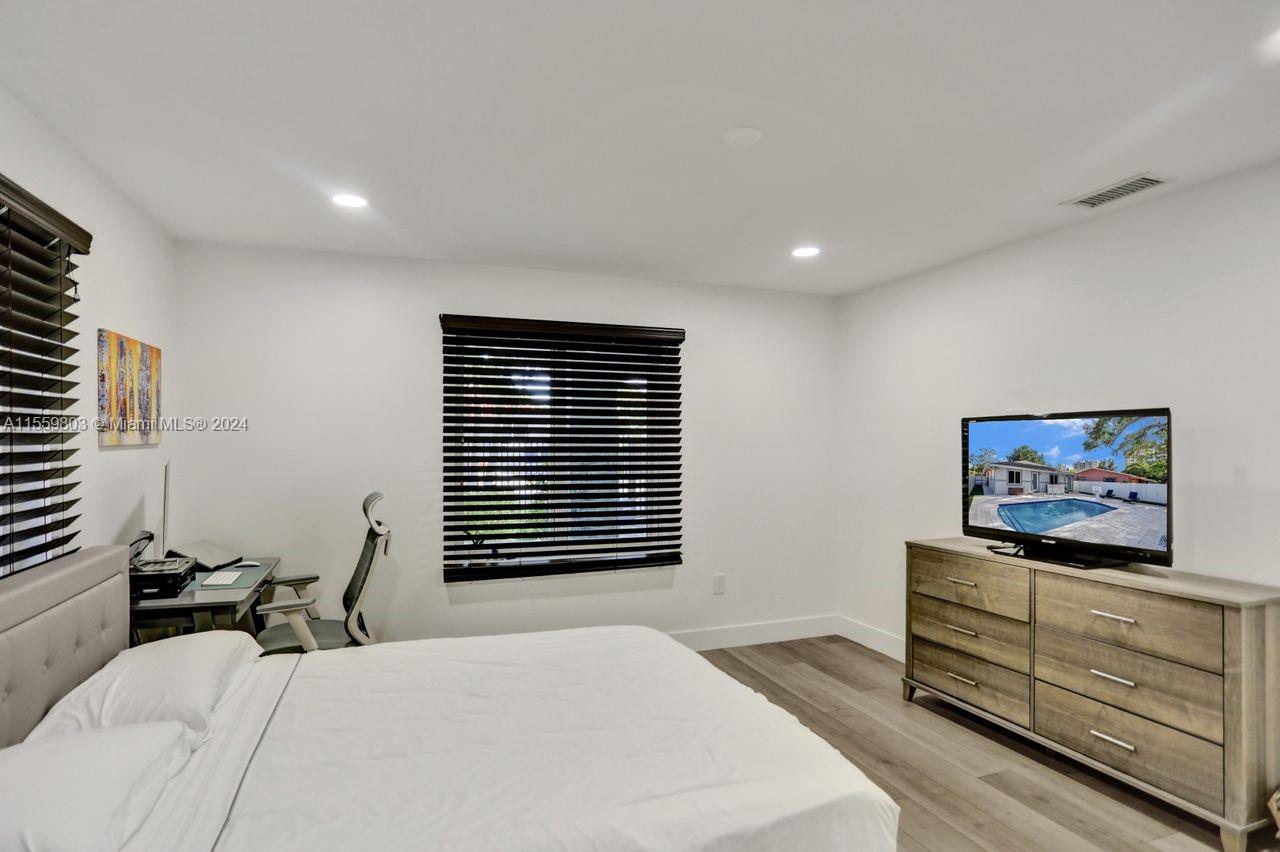 2800 Southwest 26th Street Miami, FL 33133 - Photo 49 of 72 a bedroom with furniture and a flat screen tv
